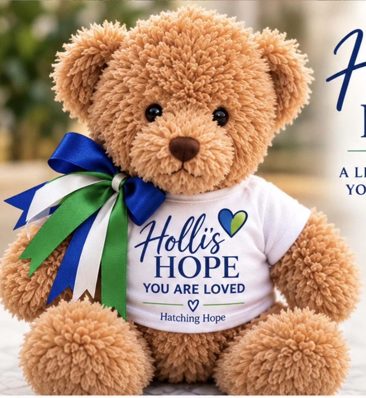 Holli's Hope commemorative teddy bear with blue and green ribbons